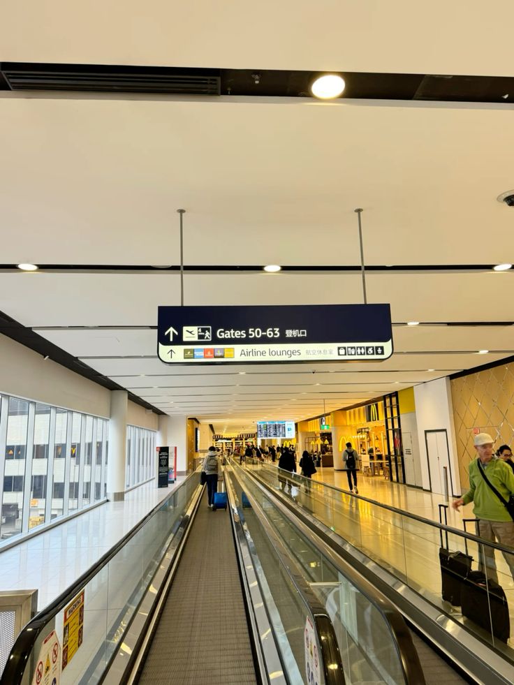 Hand holding an Australian passport and boarding pass at an airport, symbolizing the journey to Australia on a 2025 working holiday visa.
