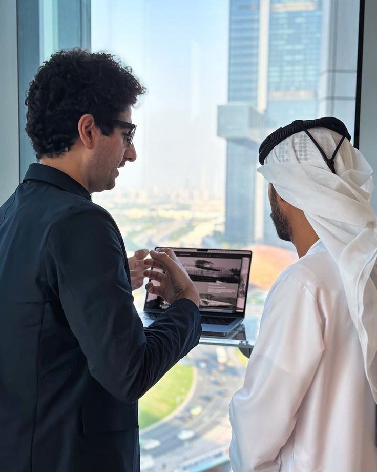 Professionals in a Dubai government office with city skyscrapers in the background, highlighting new job opportunities for expats in 2025 with salaries up to AED 25,000.