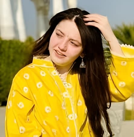 A memorial scene with candles and flowers honoring a young Pakistani TikTok influencer, reflecting the grief and tributes from the online community