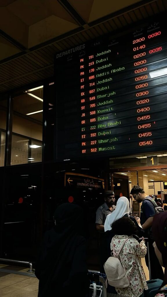 Pakistani airport employees at information counter, demonstrating diversity and professionalism in airport careers.
