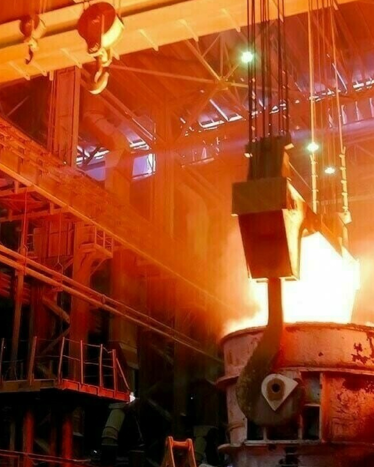 Interior view of a modern steel mill in Karachi with Russian and Pakistani engineers collaborating and molten steel being processed.