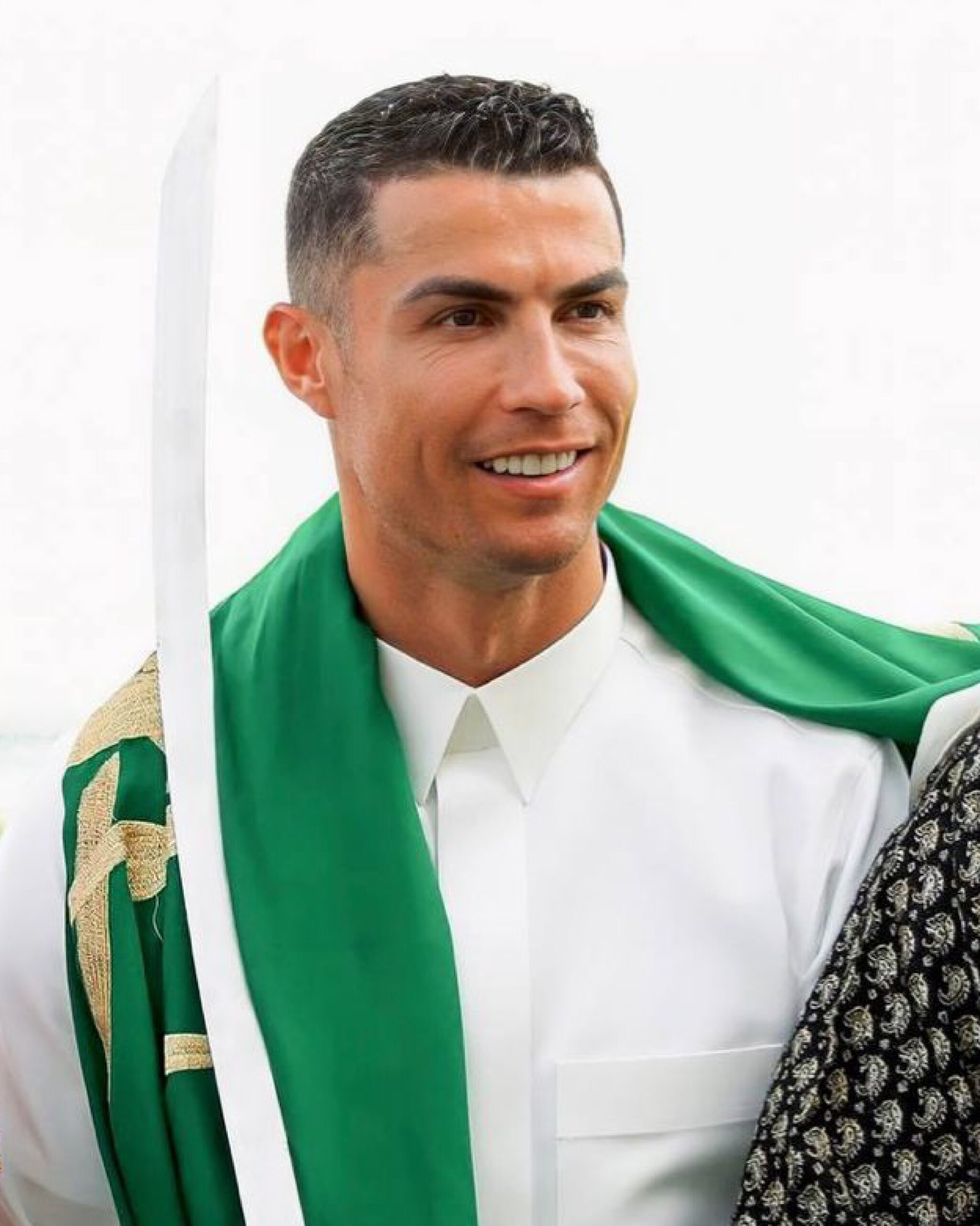 Cristiano Ronaldo in Al Nassr kit with the Saudi flag, standing before Riyadh’s skyline, surrounded by cheering fans