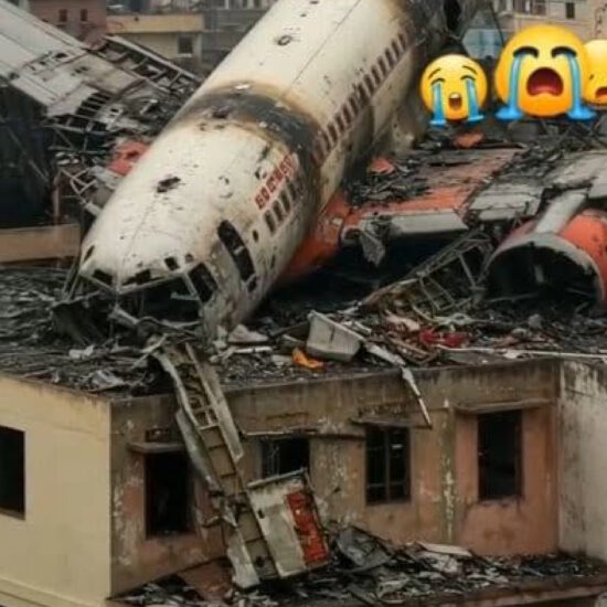 Crowds gather as firefighters work to extinguish flames after a jet crashed into a school building in Dhaka, with smoke rising and people aiding the wounded.