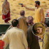A woman in traditional Balochi attire stands alone in the desert, with imposing shadows of tribal men and a blurred gavel symbolizing the tension between custom and justice.
