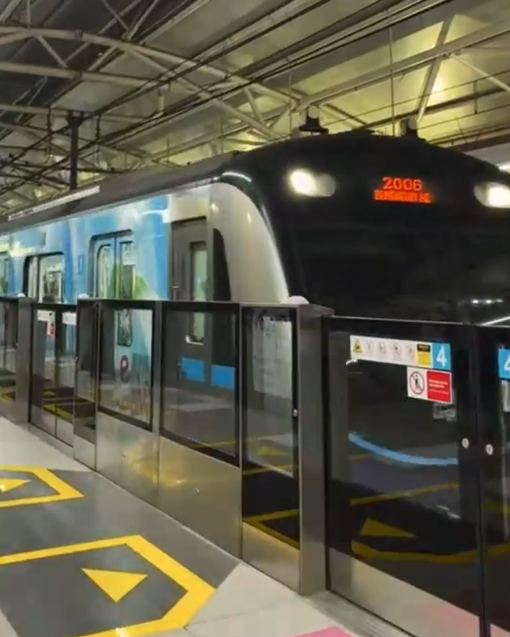 Modern train at Lahore station with passengers boarding and digital displays.