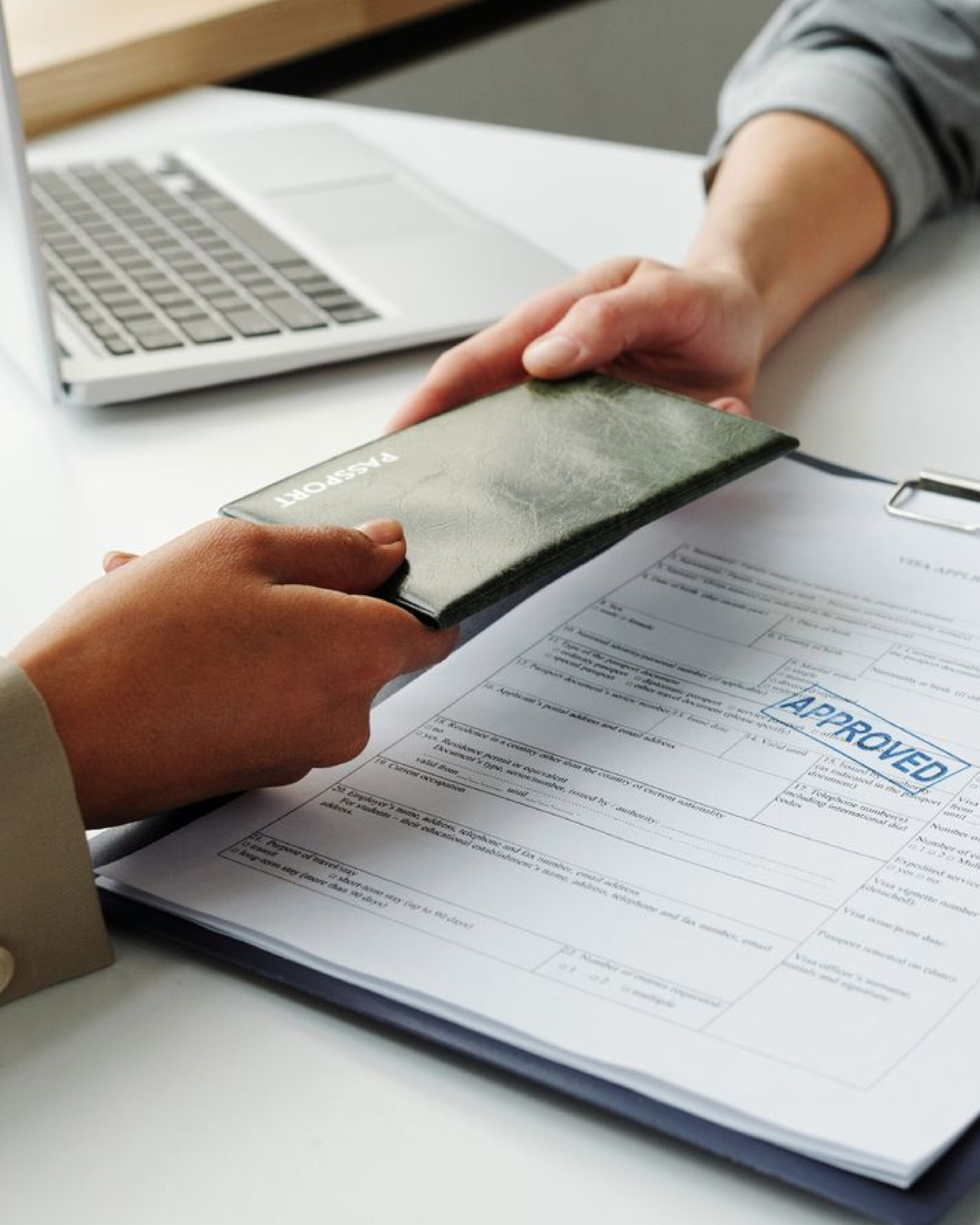 Pakistani applicant submitting documents for Australia Golden Visa at an immigration office with approved visa stamp.