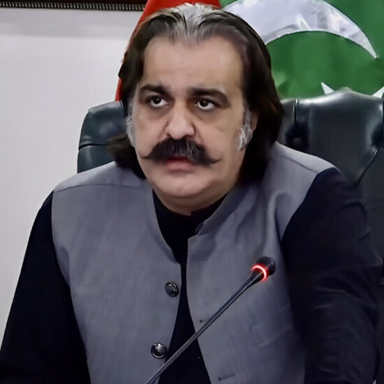 Pakistani citizens reacting with concern while watching news about the KPK biscuit spending scandal, with social media posts visible in the background.