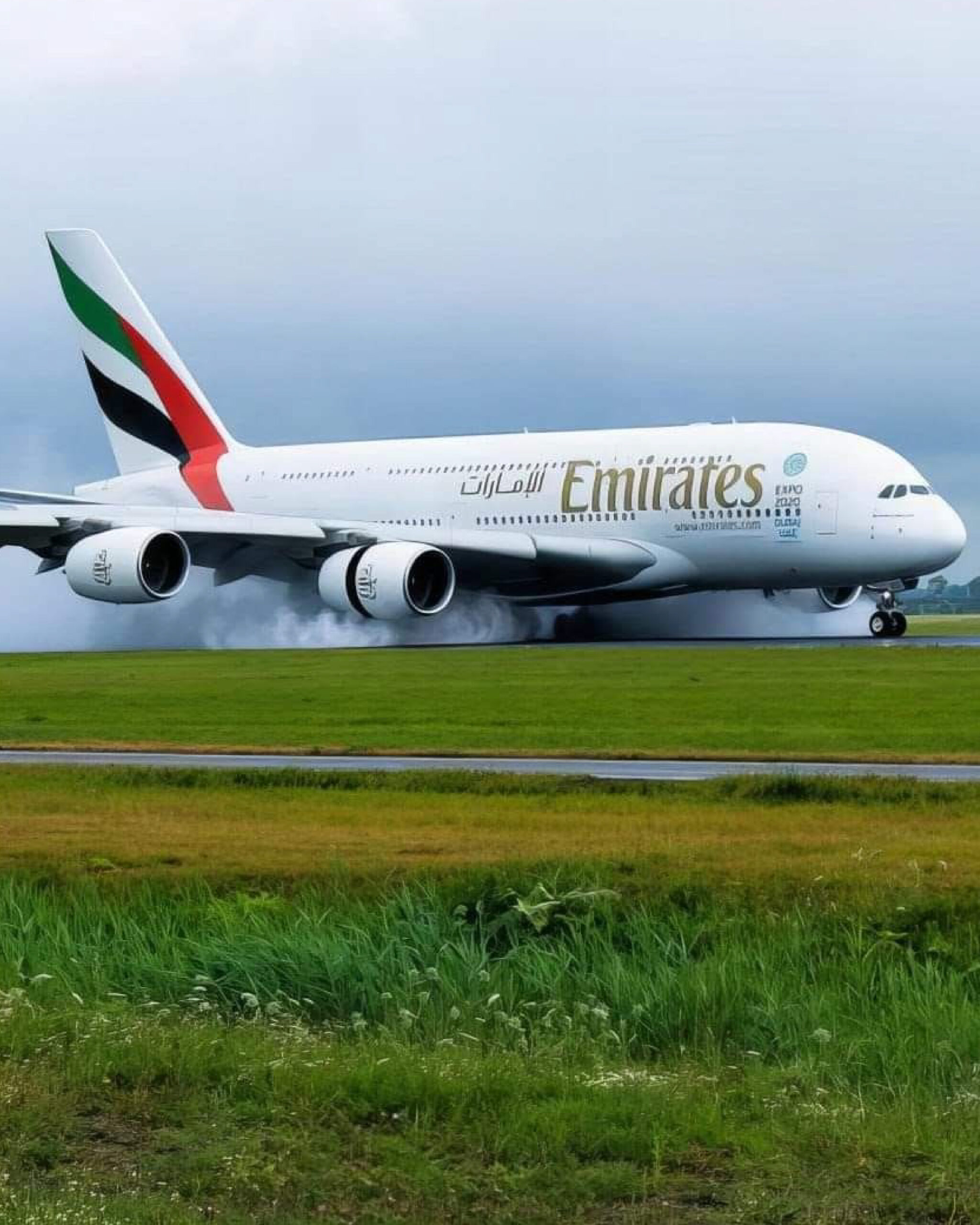 Emirates Airbus A380 flying above clouds at sunrise, representing luxury and global leadership.